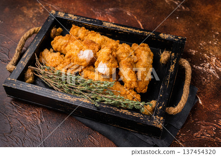Homemade Deep Fried chicken tenders or strips. brown background. top view 137454320