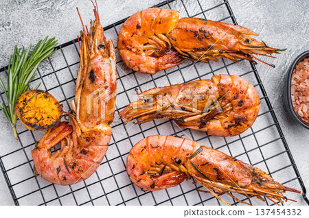 Seafood BBQ with Grilled red Argentine shrimps, Prawns Langostino Austral on a rack with herbs. grey background. top view 137454332
