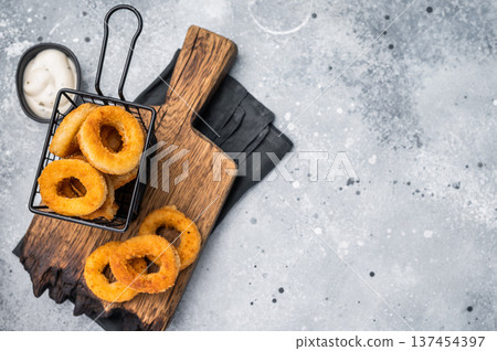 Deep Fried crunchy onion rings, delicious snack. grey background. top view 137454397