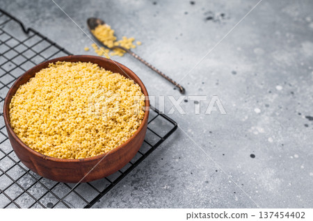 Raw stelline pasta, uncooked Italian soup Noodle in a bowl. grey background. top view 137454402