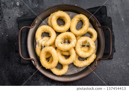 Ready for cooking Raw onion rings, uncooked vegetable. black background. top view 137454413