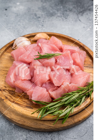 Diced raw turkey breast fillets, sliced poultry meat. grey background. top view Diced raw turkey breast fillets, sliced poultry meat. grey background. top view 137454426