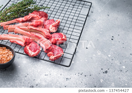 Raw lamb meat chops, fresh mutton cutlets. grey background. top view Raw lamb meat chops, fresh mutton cutlets. grey background. top view 137454427