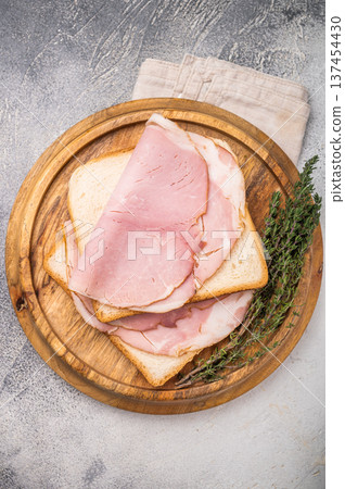 Ham sandwich, Bread with sliced pork meat. grey background. top view Ham sandwich, Bread with sliced pork meat. grey background. top view 137454430