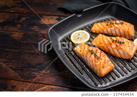 Pan fried salmon fillet steaks with thyme and lemon, fresh fish. wooden background. top view 137454434
