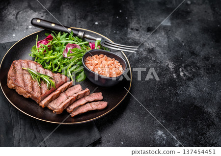 Grilled Top blade steak with salad, beef shoulder meat on a plate. black background. top view 137454451