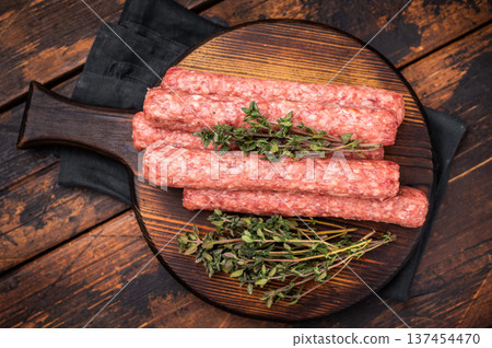 Balkan raw Cevapcici Sausage, fresh Cevapi from mince beef and pork meat. wooden background. top view Balkan raw Cevapcici Sausage, fresh Cevapi from mince beef and pork meat. wooden background. top view 137454470