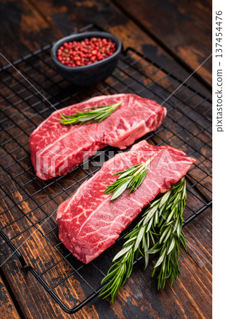 Raw Top blade steak, marbled black angus prime beef. wooden background. top view Raw Top blade steak, marbled black angus prime beef. wooden background. top view 137454476