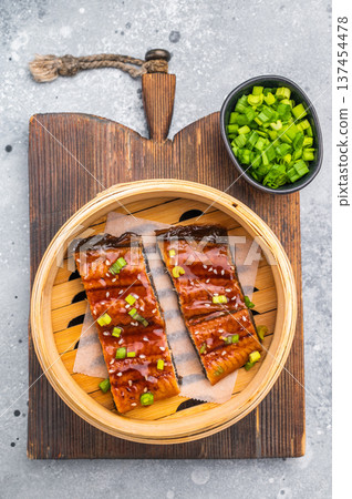 Unagi eel, Japanese grilled eel with sweet soy sauce. grey background. top view Unagi eel, Japanese grilled eel with sweet soy sauce. grey background. top view 137454478