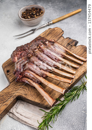 Grilled Rack of lamb, mutton meat chop steaks on wooden board. grey background. top view Grilled Rack of lamb, mutton meat chop steaks on wooden board. grey background. top view 137454479