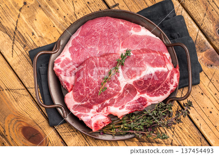 Uncooked pork tender steak, raw sliced neck meat with thyme. wooden background. top view 137454493