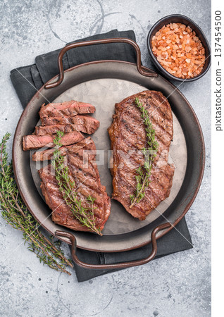 Roast Top blade steak, grilled beef shoulder meat. grey background. top view Roast Top blade steak, grilled beef shoulder meat. grey background. top view 137454500