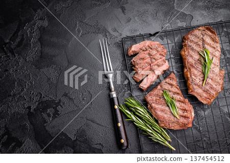 Grilled Top blade steak, shoulder beef meat. black background. top view Grilled Top blade steak, shoulder beef meat. black background. top view 137454512