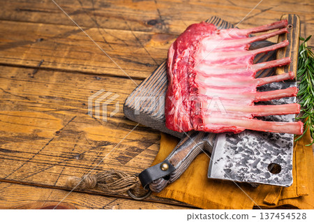 Butcher board with Raw lamb meat for chops steaks, fresh rack of mutton. wooden background. top view Butcher board with Raw lamb meat for chops steaks, fresh rack of mutton. wooden background. top view 137454528