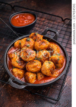 Juicy meatballs, perfectly seasoned and beautifully browned, ready to be served with marinara sauce. A classic comfort food that never disappoints. brown background. top view 137454591