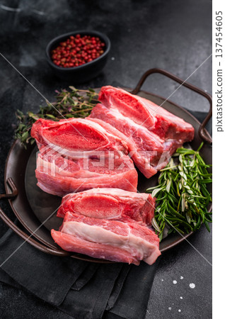 Raw Beef Short Rib, uncooked meat with bone and fat. black background. top view Raw Beef Short Rib, uncooked meat with bone and fat. black background. top view 137454605
