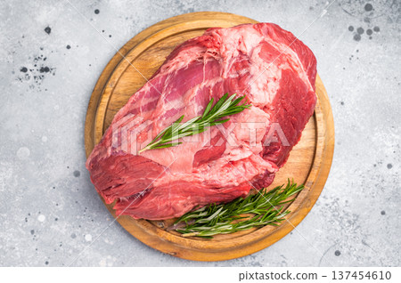 A selection of fresh beef shin, boneless shank meat cuts on a butcher block, emphasizing their quality and versatility for various cooking methods. greybackground. top view 137454610