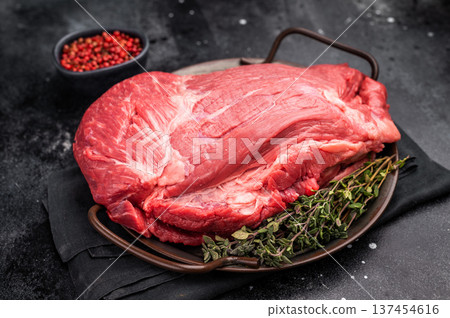 Raw Top Round beef meat cut, topside with hrebs for roast. black background. Top view 137454616