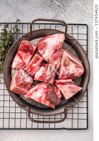 Raw Beef meat and veal bones for stew or goulash. grey background. top view Raw Beef meat and veal bones for stew or goulash. grey background. top view 137454620