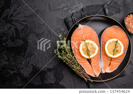 High-quality salmon portion, ready to be transformed into a gourmet dish. A versatile ingredient for both traditional and modern recipes. black background. top view 137454624