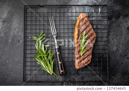 Grilled Brazilian picanha, rump cap beef steak. black background. top view 137454645
