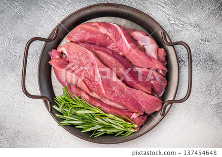 Slices of duck breast fillet, raw fresh poultry meat. grey background. top view Slices of duck breast fillet, raw fresh poultry meat. grey background. top view 137454648