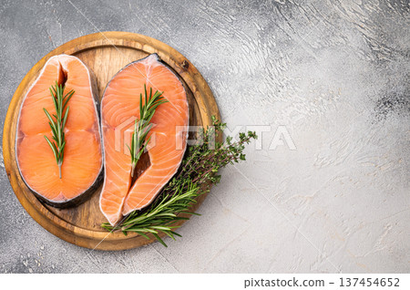 Premium salmon loin steak, expertly cut and displayed, perfect for culinary creations. Elevate your dishes with this delicious seafood option. grey background. top view Premium salmon loin steak, expertly cut and displayed, perfect for culinary creations. Elevate your dishes with this delicious seafood option. grey background. top view 137454652