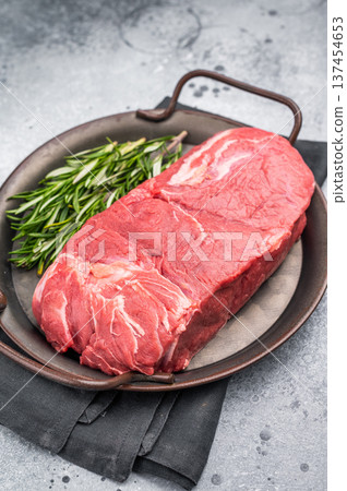 Freshly cut horse meat pieces arranged artfully, showcasing their tender texture and deep red hue, perfect for gourmet recipes. grey background. top view Freshly cut horse meat pieces arranged artfully, showcasing their tender texture and deep red hue, perfect for gourmet recipes. grey background. top view 137454653