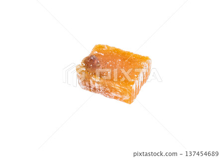 Amber lokum jelly candy cubes with almond and hazelnut pieces. Soft chewy gourmet sweets isolated on white background. Amber lokum jelly candy cubes with almond and hazelnut pieces. Soft chewy gourmet sweets isolated on white background. 137454689