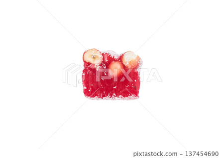 Turkish delight lokum cubes with hazelnuts and almonds coated in coconut flakes. Sweet jelly candy isolated on white background.. 137454690