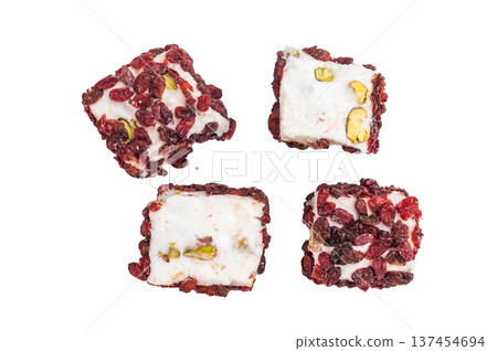 White pistachio lokum covered with dried cranberries. Gourmet jelly candy photographed from above, isolated. White pistachio lokum covered with dried cranberries. Gourmet jelly candy photographed from above, isolated. 137454694