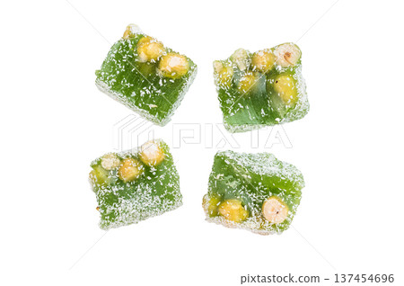 Chewy lokum dessert cubes with nut pieces and sugar coating. Colorful oriental style sweets isolated on clean white background. Chewy lokum dessert cubes with nut pieces and sugar coating. Colorful oriental style sweets isolated on clean white background. 137454696