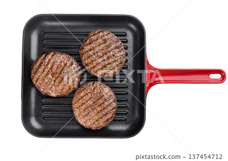 Grilled beef and lamb burger patties with seared crust in cast iron grill pan. Cooked juicy meat on isolated background with copy space. Grilled beef and lamb burger patties with seared crust in cast iron grill pan. Cooked juicy meat on isolated background with copy space. 137454712