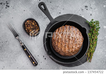 Grilled beef lamb burger patty cooked to perfection with crispy crust and moist center. Gourmet meat cutlet in skillet on stone. Grilled beef lamb burger patty cooked to perfection with crispy crust and moist center. Gourmet meat cutlet in skillet on stone. 137454722