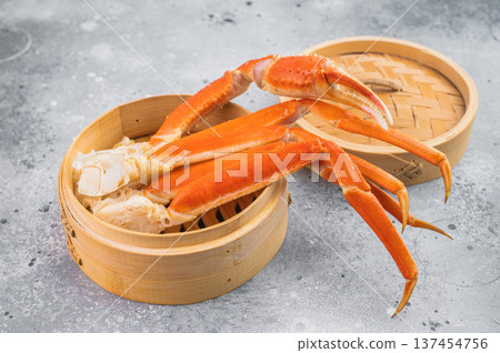 Luxury kamchatka red crab legs served in bamboo steamer on light textured background gourmet seafood overhead composition 137454756