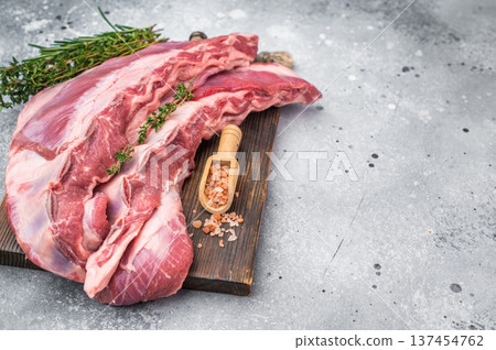 Uncooked lamb belly breast cut with rosemary thyme and salt on wooden board light background butcher style preparation with copy space Uncooked lamb belly breast cut with rosemary thyme and salt on wooden board light background butcher style preparation with copy space 137454762