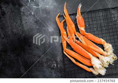 Cooked king red kamchatka crab legs on metal rack over dark background premium seafood with copy space for menu design Cooked king red kamchatka crab legs on metal rack over dark background premium seafood with copy space for menu design 137454768