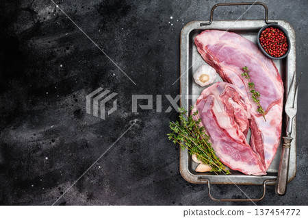 Raw lamb ribs and breast on metal tray with herbs garlic and pepper on dark background copy space rustic butcher meat preparation 137454772