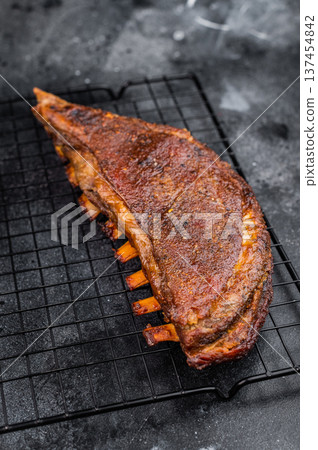 Grilled lamb breast ribs with crispy crust on dark stone background barbecue meat with copy space 137454842