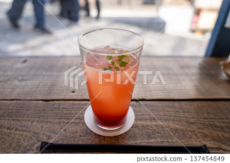 Red drink by the cafe window 137454849