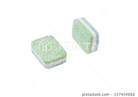 Green and white dishwashing tablets on clean white backdrop symbolizing hygiene household cleaning and modern kitchen care 137454888