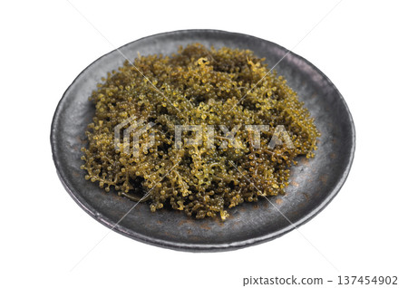 Fresh sea grapes also known as green caviar and sea caviar served in bowl on isolated background exotic Japanese umibudo seaweed 137454902