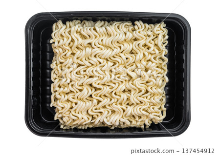 Raw dehydrated ramen noodles in square block form on clean white studio background minimal food ingredient texture detail 137454912