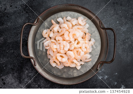 Small prawns in vintage pan on black background, seafood cooking ingredient with copy space for restaurant and food branding. 137454928