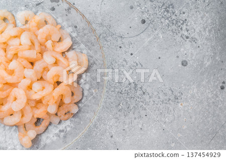 Mini peeled prawns portion, frozen salad shrimp in transparent plate, clean protein seafood ingredient for diet and catering concept. 137454929