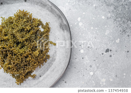 Raw umibudo sea grapes also called green caviar and sea caviar on ceramic dish with copy space tropical marine superfood Raw umibudo sea grapes also called green caviar and sea caviar on ceramic dish with copy space tropical marine superfood 137454938