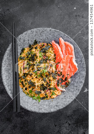 Bowl of spicy seafood ramen noodles with crab sticks nori and sesame on dark background Asian comfort food top view Bowl of spicy seafood ramen noodles with crab sticks nori and sesame on dark background Asian comfort food top view 137454961