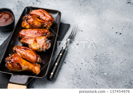 Juicy barbecue chicken wings, perfectly grilled and glazed, ideal for your next summer cookout or party. grey background. top view 137454976