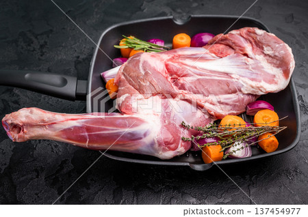 High quality raw lamb shoulder leg, an essential ingredient for hearty stews and savory dishes. black background. top view 137454977