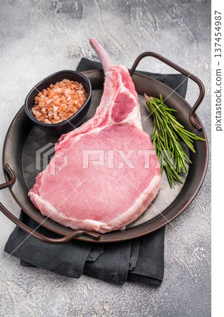 Raw pork rib chop steak, highlighting the rich texture and flavor that will elevate your next barbecue feast. white background. top view Raw pork rib chop steak, highlighting the rich texture and flavor that will elevate your next barbecue feast. white background. top view 137454987